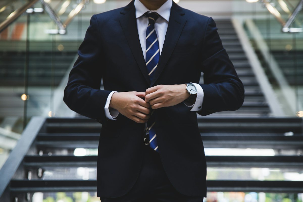 Professional in a suit standing near stairs
