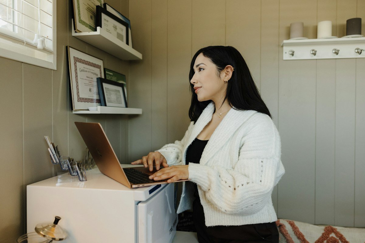 Woman working on a laptop at her desk